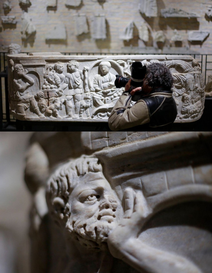 A photographer takes pictures of a marble low-relief decorating a sarcophagus inside the catacomb of Priscilla. (Photo: REUTERS/Max Rossi)