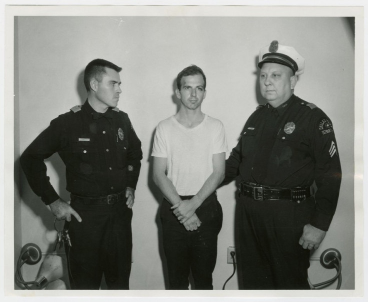ee Harvey Oswald, accused of assassinating former U.S. President John F. Kennedy, is pictured with Dallas police Sgt. Warren (R) and a fellow officer in Dallas