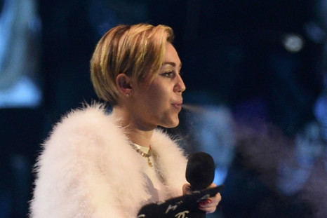 Singer Miley Cyrus smokes on stage after receiving the Best Video award during the 2013 MTV Europe Music Awards at the Ziggo Dome in Amsterdam