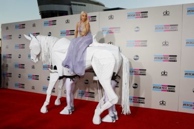 Musician Lady Gaga arrives atop a horse puppet
