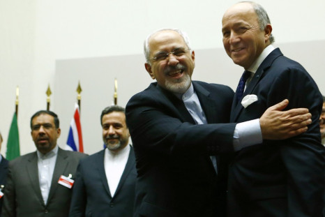 Iran's foreign minister Mohammad Javad Zarif (L) hugs his French counterpart, Laurent Fabius