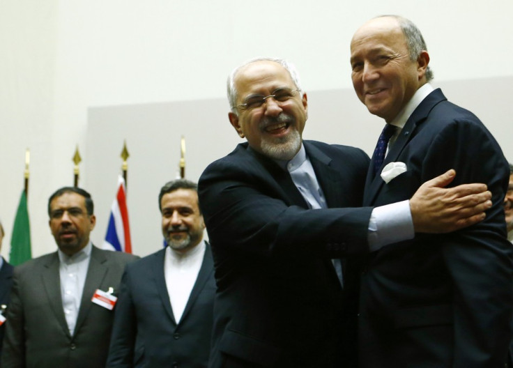 Iran's foreign minister Mohammad Javad Zarif (L) hugs his French counterpart, Laurent Fabius
