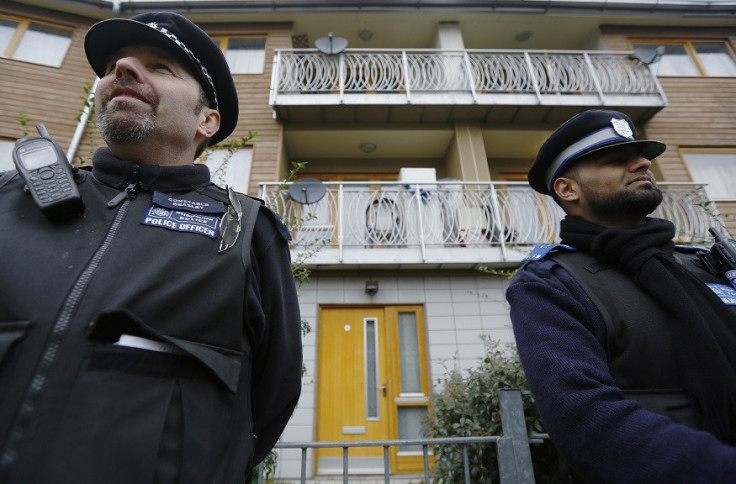 Police stand guard at a property in Brixton, south London where the three women escaped (Reuters)