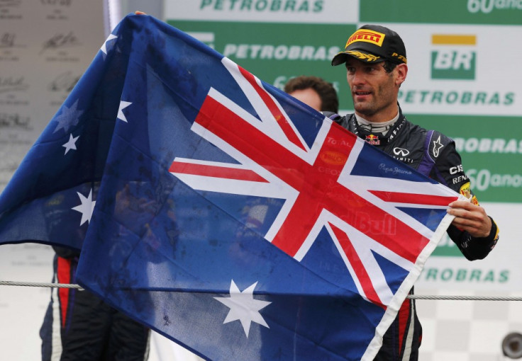 Red Bull Formula One driver Mark Webber of Australia holds up the Australian flag during podium celebrations after the Brazilian F1 Grand Prix at the Interlagos circuit in Sao Paulo November 24, 2013. REUTERS/Paulo Whitaker