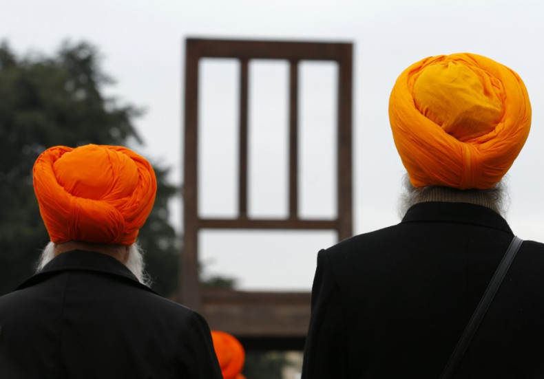 Sikh minority representatives stand in front of the European headquarters of the United Nations in Geneva