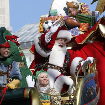 Santa and his elves on a float in Central Park West during the Thanksgiving Day Parade, New York
