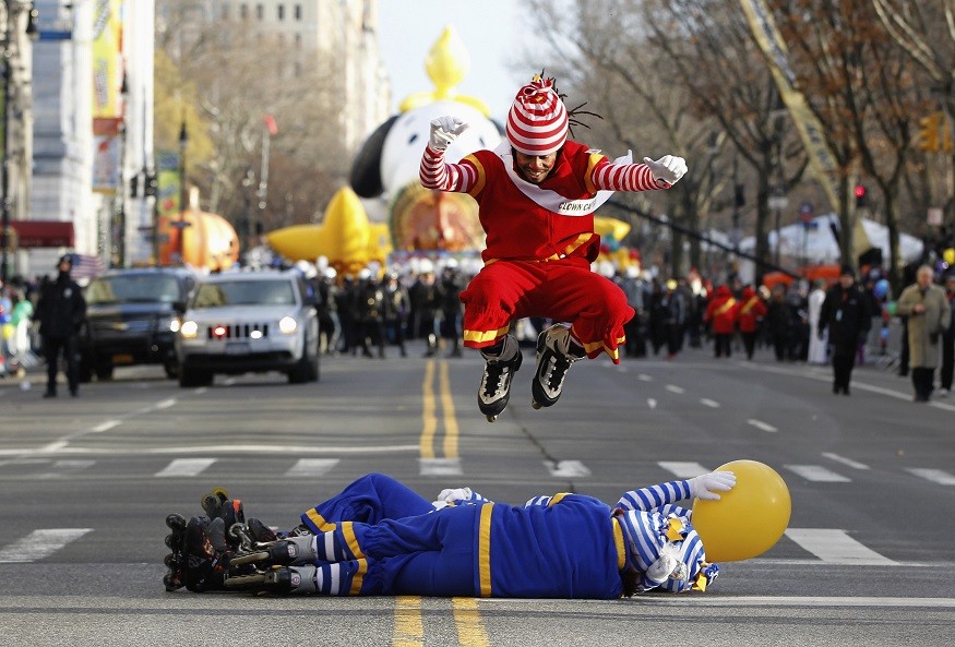 Clown leaps over comrades before the start of the Thanksgiving Day Parade in New York