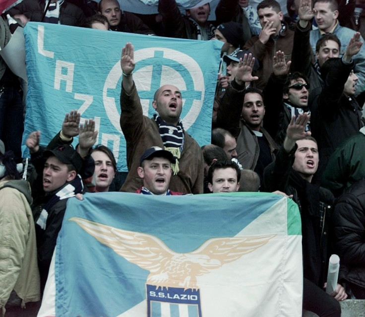Fans for Italian team Lazio give the Nazi salute as they hold team banners