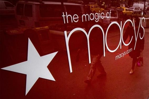 People are reflected in a window outside the Macy's department store in New York, in this November 22, 2013 file photo.