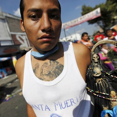 Santa Muerte follower holds a figure of the ‘saint’, which is blamed for a rise in exorcisms and drug-related violence in Mexico. (Reuters)