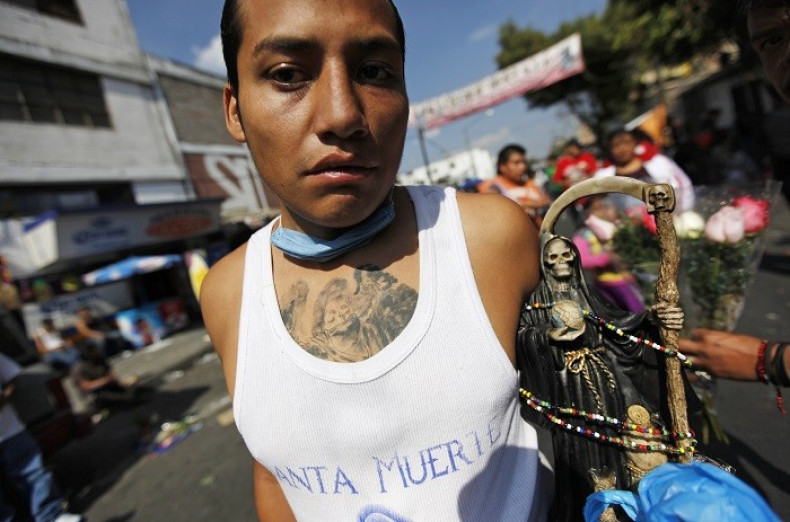 Santa Muerte follower holds a figure of the ‘saint’, which is blamed for a rise in exorcisms and drug-related violence in Mexico. (Reuters)
