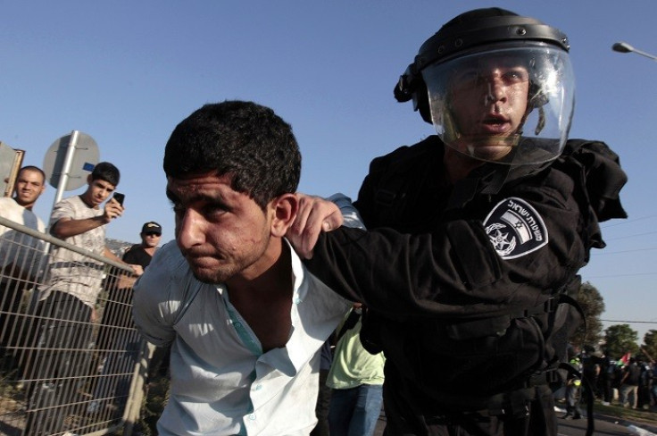 An Israeli policeman detains a protester during a demonstration in solidarity with Palestinian Bedouins. (Reuters)