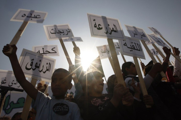 Israeli Arab children hold placards, some of which name Bedouin villages not recognised by Israel. (Reuters) Israeli Arab children hold placards, some of which name Bedouin villages not recognised by Israel. (Reuters)