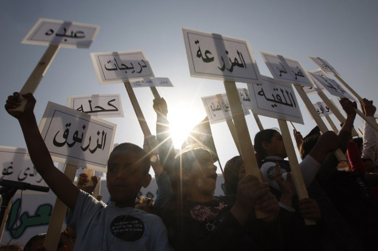 Israeli Arab children hold placards, some of which name Bedouin villages not recognised by Israel. (Reuters)