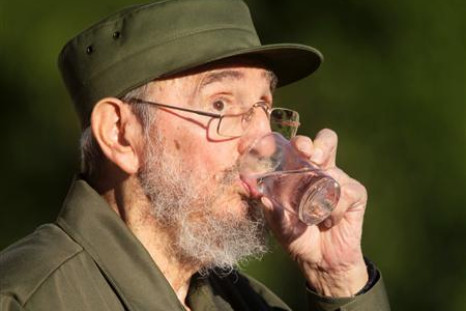 Former Cuban leader Fidel Castro drinks water during a meeting with students at Havana's University