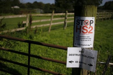 An anti high speed rail project (HS2) banner is seen nailed to a fence post near the village of Pickmere, northern England