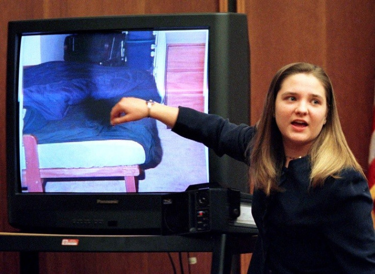 During her murder trial, Louise Woodward points to a bed where she put baby Matthew on the day he was taken to hospital. (Reuters)