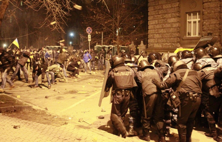 Protesters throw stones at police during a rally held by supporters of EU integration in Kiev December