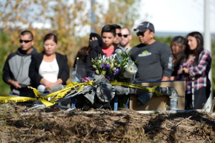 Fans gather and place flowers at the scene of a fiery crash that killed "Fast and Furious" actor Paul Walker
