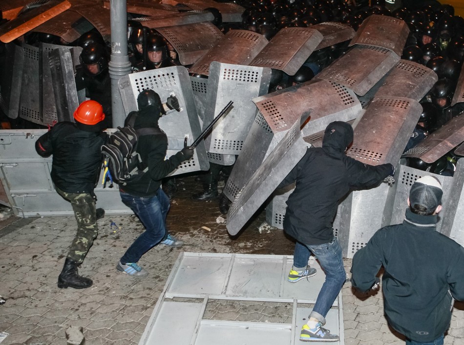 Protesters try to break through police lines near the presidential administration building during a rally held by supporters of EU integration in Kiev