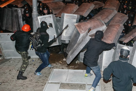 Protesters try to break through police lines near the presidential administration building during a rally held by supporters of EU integration in Kiev