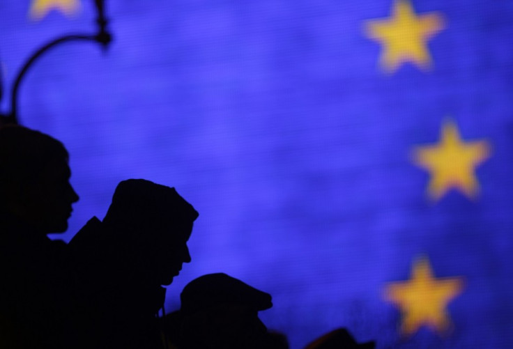 Protesters are silhouetted against a giant screen displaying the European Union flag during a demonstration at Independence Square Protesters are silhouetted against a giant screen displaying the European Union flag during a demonstration at Independence Square