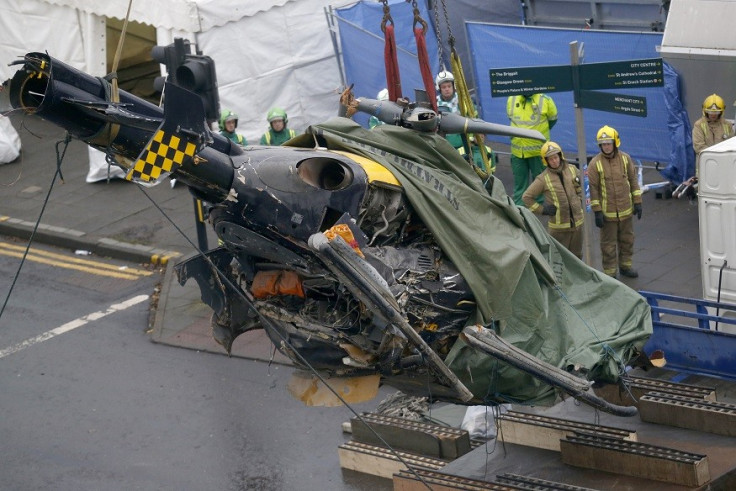 Emergency services remove the remains of the police helicopter which crashed in to the Clutha pub in Glasgow PIC: Reuters