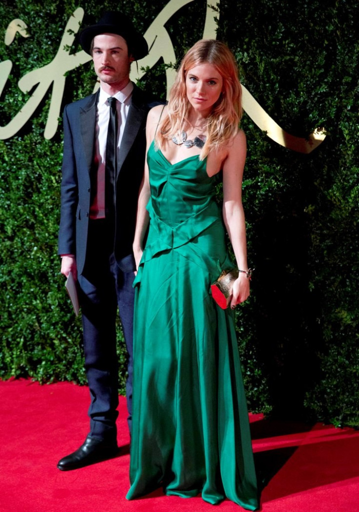 Sienna Miller shows off her emerald dress. (Photo: REUTERS/Neil Hall)