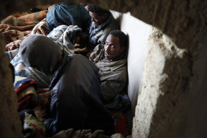 Migrants from Eritrea rest in a building, used to house people waiting to be smuggled into Israel, near the Egyptian-Israeli border in Sinai