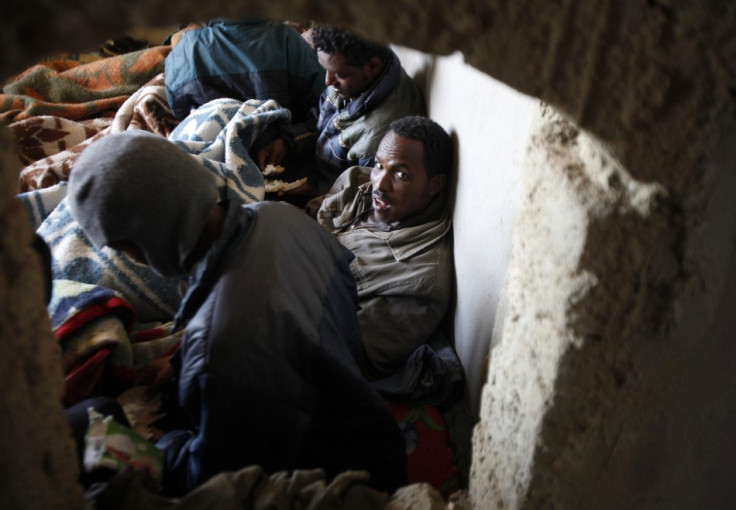 Migrants from Eritrea rest in a building, used to house people waiting to be smuggled into Israel, near the Egyptian-Israeli border in Sinai