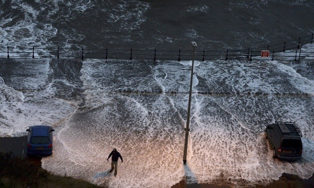 A man stands in water washed onto the promenade of the north bay in Scarborough (Reuters) A man stands in water washed onto the promenade of the north bay in Scarborough (Reuters)