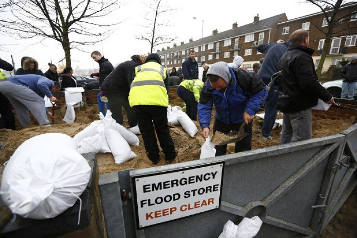 Residents fill sand bags before an expected storm surge in Great Yarmouth (Reuters)