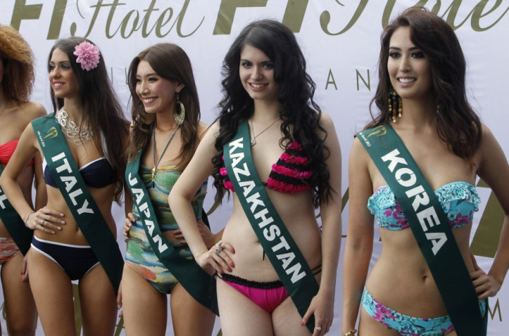 Miss Earth 2013 beauty contestants pose for a photographers during a media presentation at a hotel in Taguig city, metro Manila - Reuters.