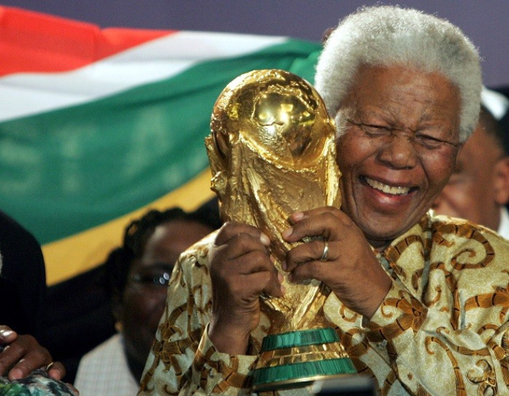 Nelson Mandela holds the World Cup trophy after South Africa is chosen to host the 2010 World Cup tournament. (Reuters)