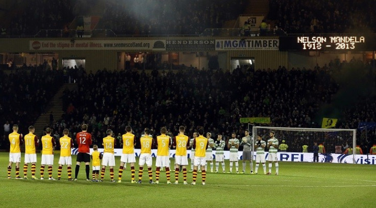 Motherwell and Celtic players take part in a minute's applause in honour of Nelson Mandela before their Scottish Premier League football match at Fir Park Stadium. (Reuters)