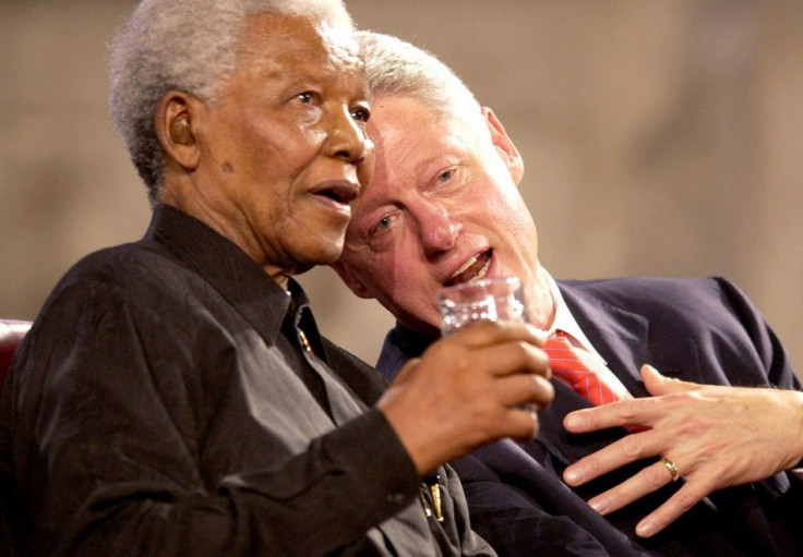 Former US President Bill Clinton (R) and former South African President Nelson Mandela (L) speak during a Gala night in Westminster Hall, London, July 2, 2003.
