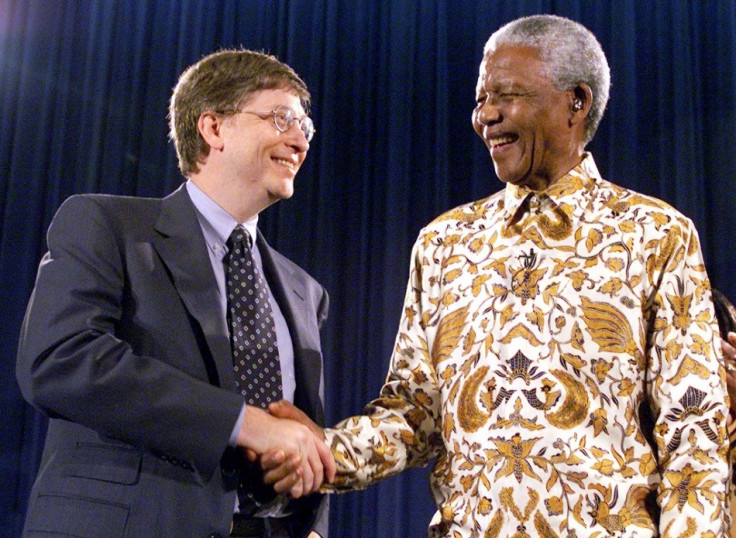 Nelson Mandela, former President of South Africa, (R) shakes hands with Bill Gates, chairman and CEO of Microsoft, at a global health discussion in Seattle in 1999.