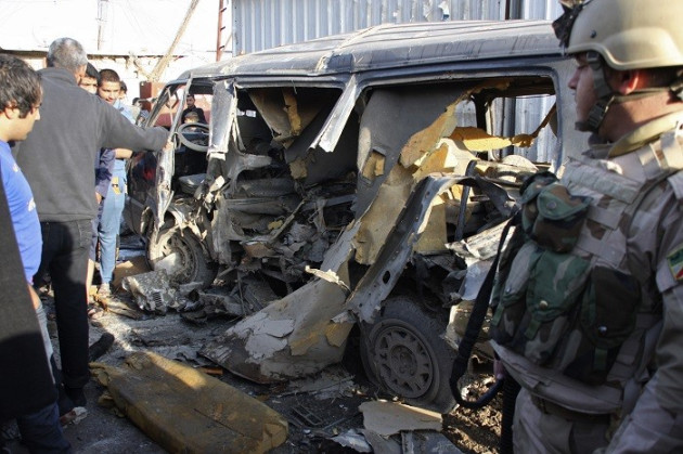 Iraqi security personnel stand in front of the site of car bomb attack in Baghdad's Sadr City on Sunday. (Reuters) Iraqi security personnel stand in front of the site of car bomb attack in Baghdad's Sadr City on Sunday. (Reuters)