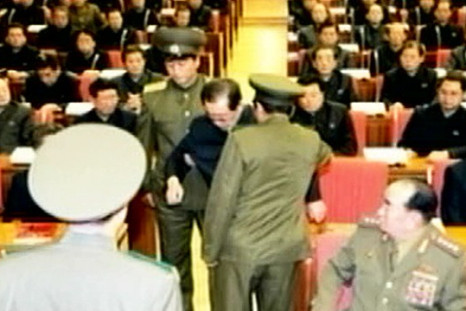 Jang being taken away by uniformed guards