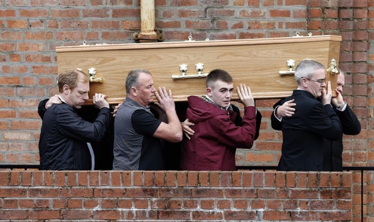 Liam O'Prey, (in burgandy jacket) helps carry the coffin of father Mark O'Prey at East Kilbride PIC: Reuters