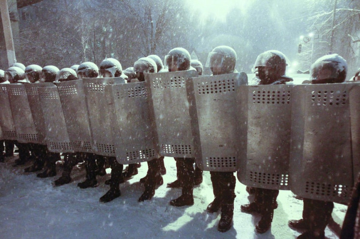 Interior Ministry personnel block a street during a gathering of supporters of EU integration during snowfall in Kiev