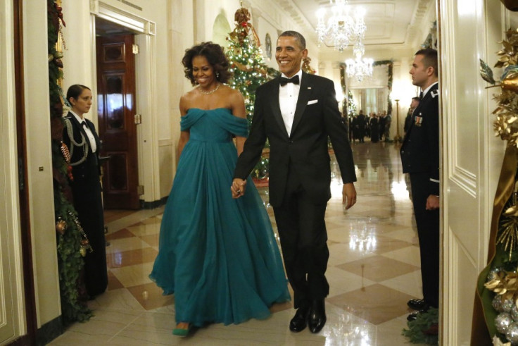 U.S. President Barack Obama and first lady Michelle Obama arrive for a reception for the 2013 Kennedy Center Honors recipients at the White House in Washington