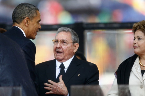 U.S. President Barack Obama (L) greets Cuban President Raul Castro (C) before giving his speech