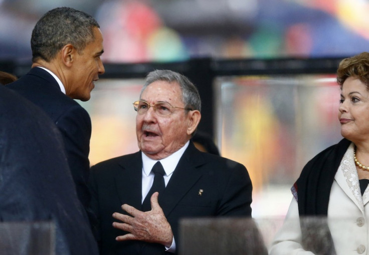 U.S. President Barack Obama (L) greets Cuban President Raul Castro (C) before giving his speech