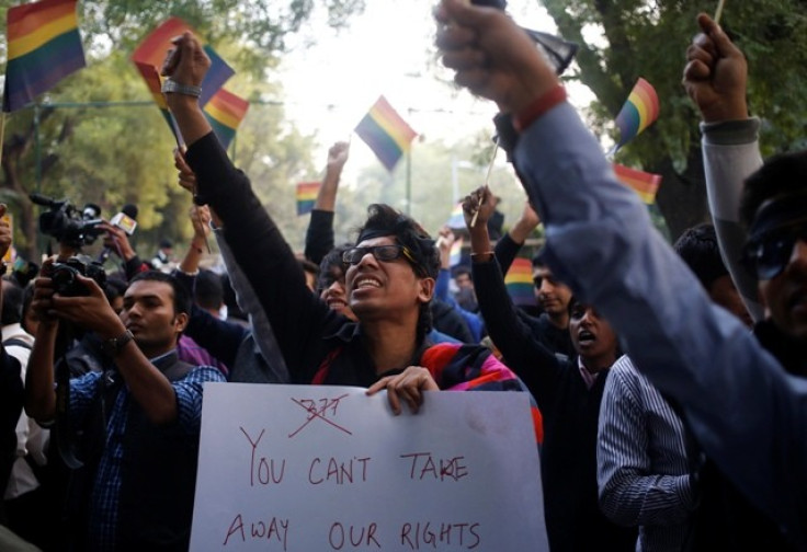 Gay rights activists wave flags and shout slogans as they attend a protest against a verdict by the Supreme Court in New Delhi December 11, 2013.