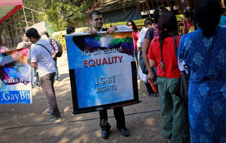 A gay rights activist folds a banner at a protest organised against the Supreme Court's order on gay sex in Mumbai December 11, 2013.