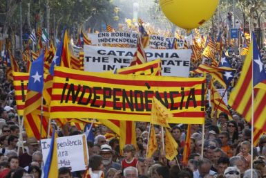 People take to the streets with a banner reading "independence" during a protest for greater autonomy for Catalonia within Spain in central Barcelona