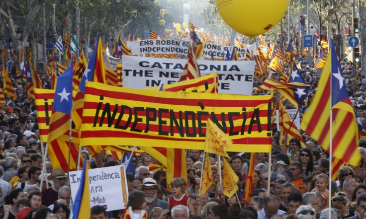 People take to the streets with a banner reading "independence" during a protest for greater autonomy for Catalonia within Spain in central Barcelona