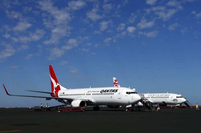 A Qantas Airlines Boeing 737 plane sits next to a Virgin Australia Boeing 737 plane at the Port Hedland airport in the Pilbara region of western Australia December 3, 2013. Ratings agency Standard