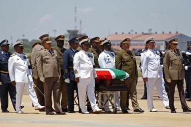 The coffin of former South African President Nelson Mandela is escorted aboard a military cargo plane. (Reuters picture)